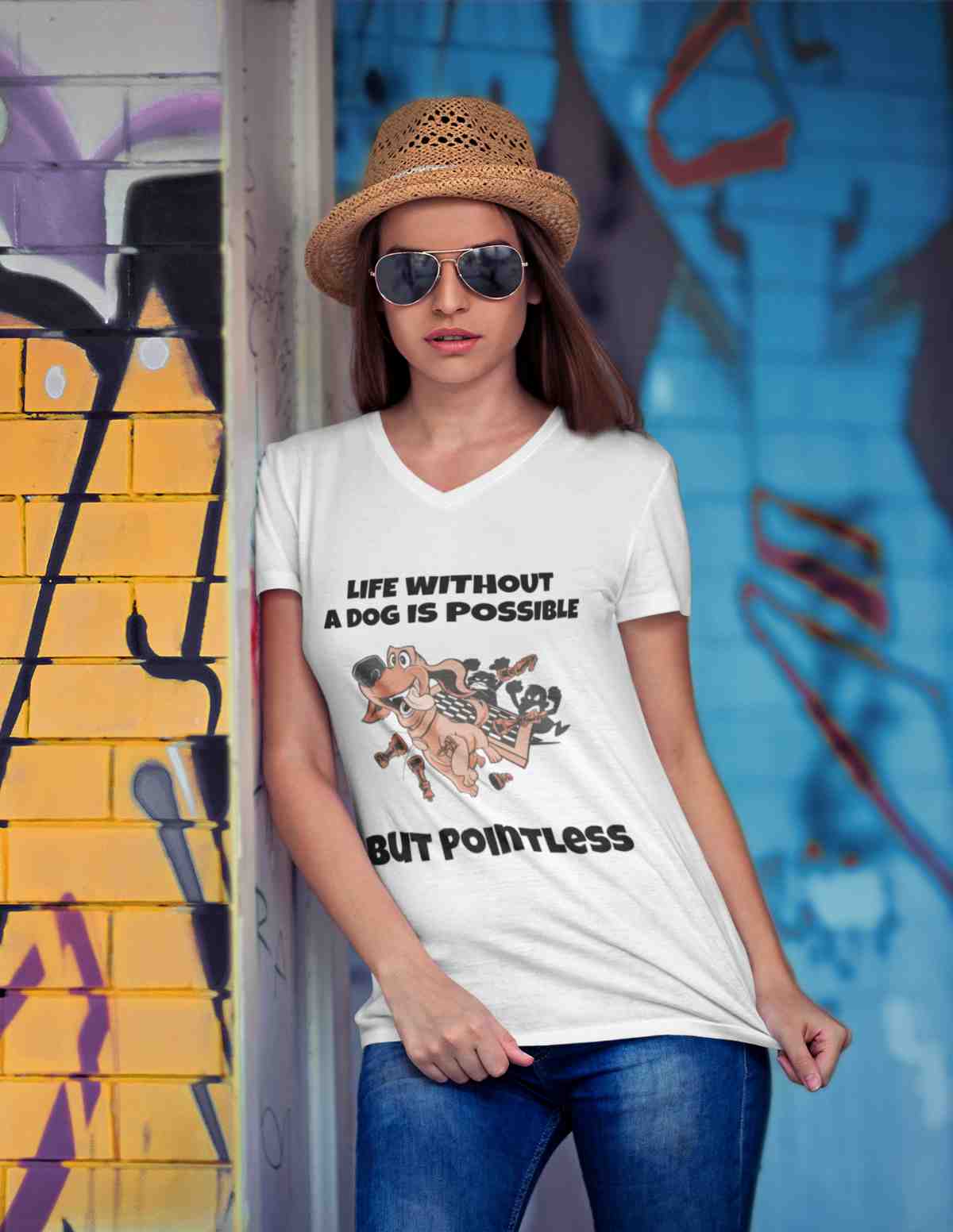 Woman in front of a graffiti painted wall, wearing a Baerenstyle Strolche V-Neck Shirt.